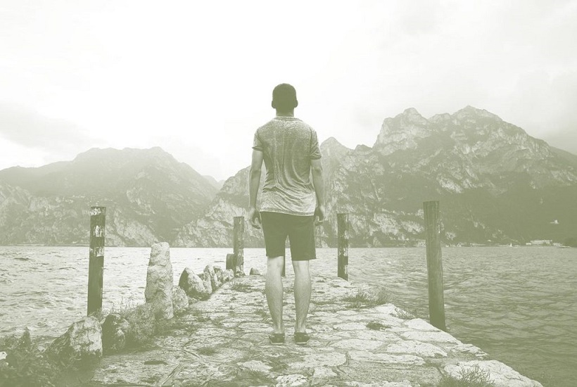 man walking along pier